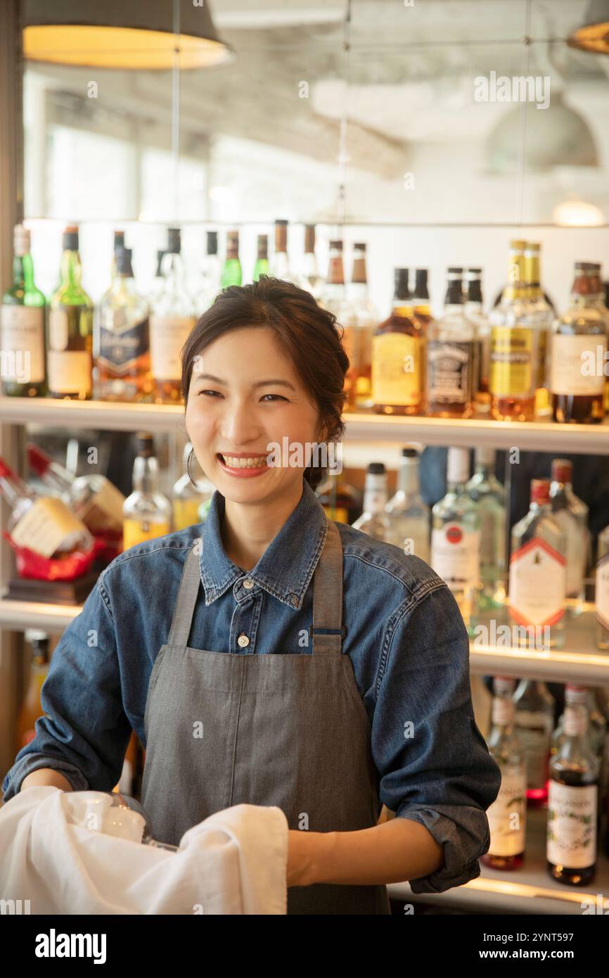 Woman in her 20s working in a café Stock Photo - Alamy