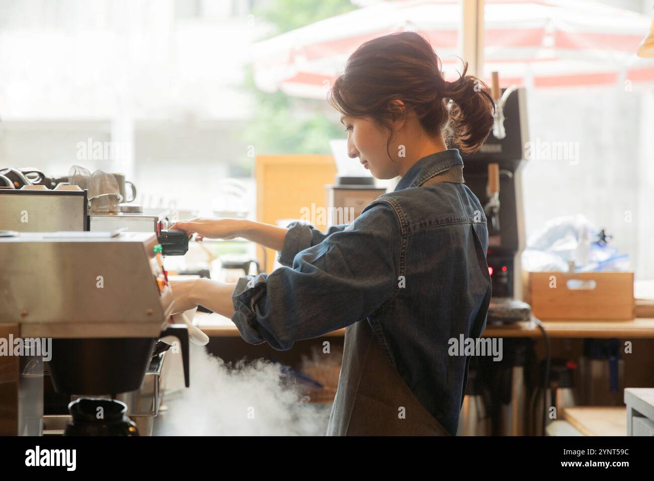 Woman making espresso Stock Photo