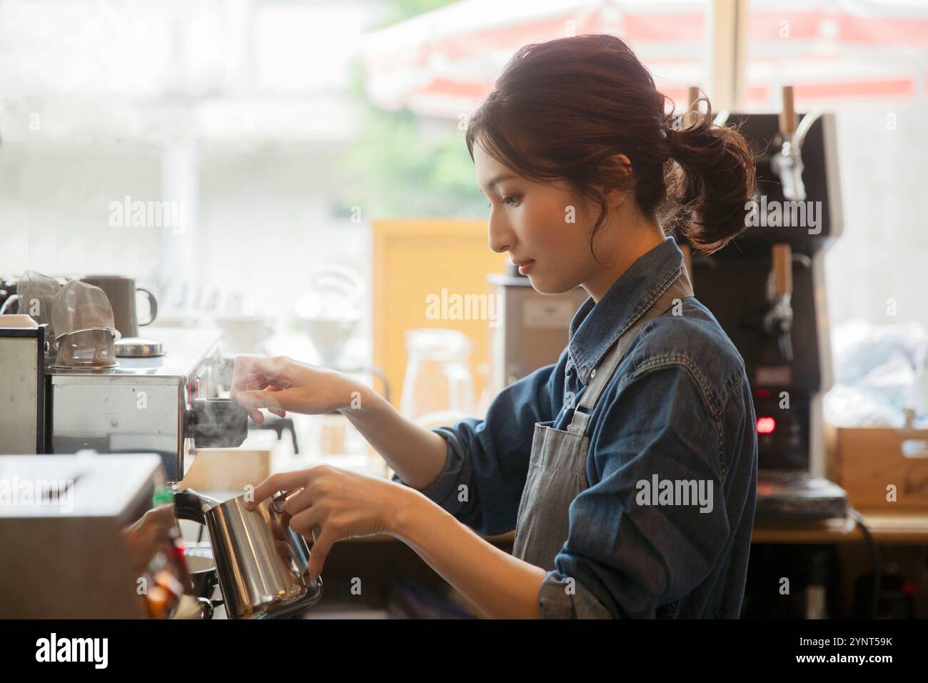 Woman making espresso Stock Photo