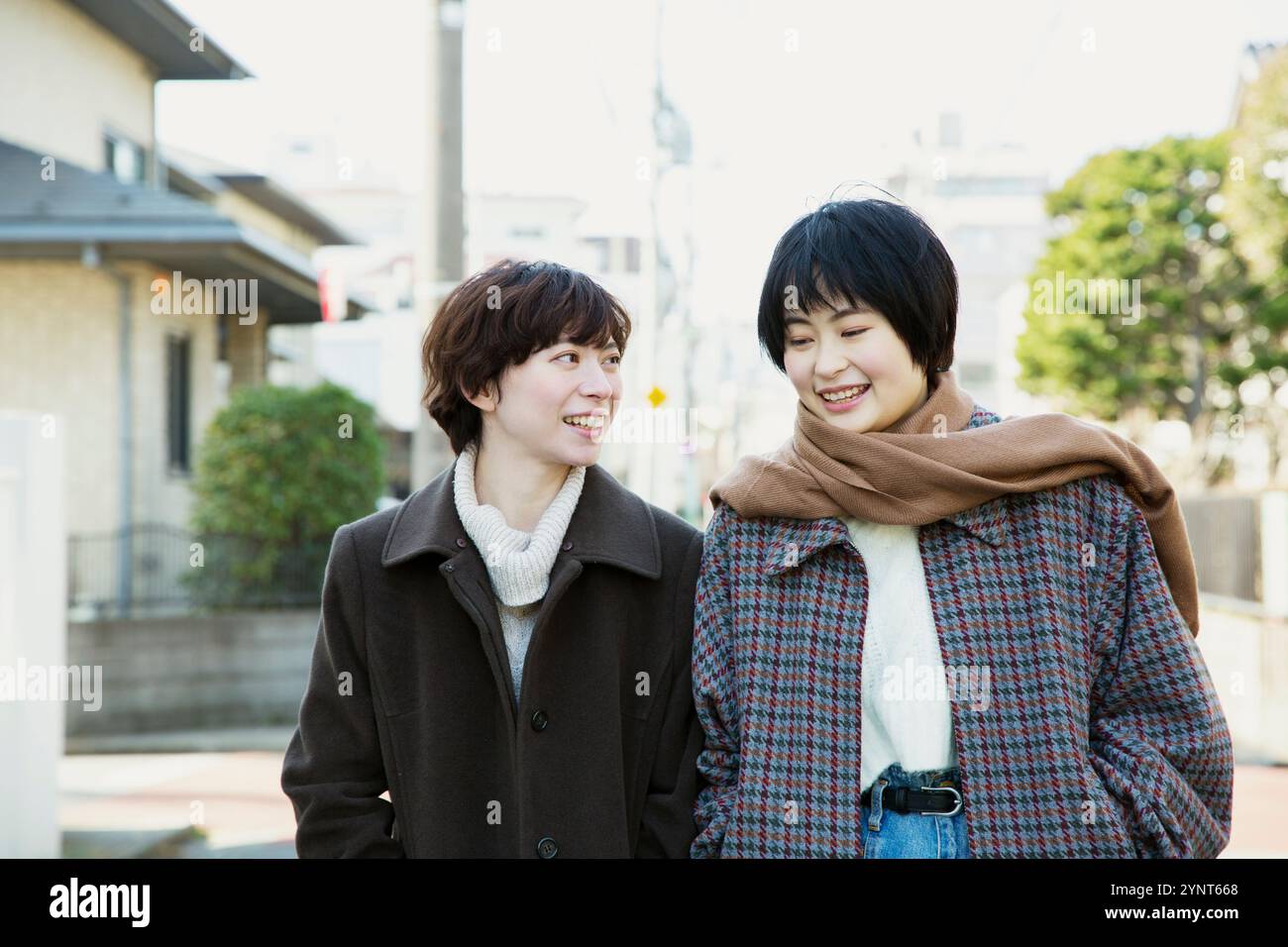Two women in their 20s taking a walk Stock Photo - Alamy