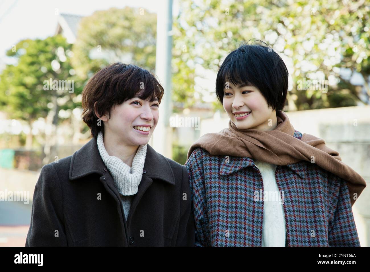Two women in their 20s taking a walk Stock Photo - Alamy
