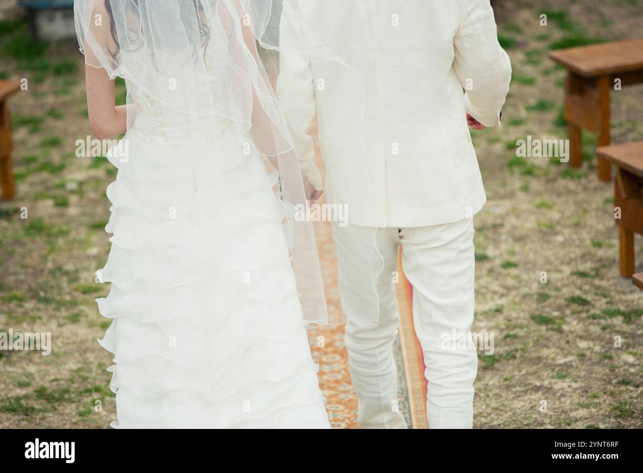 Back view of bride and groom walking down aisle Stock Photo - Alamy
