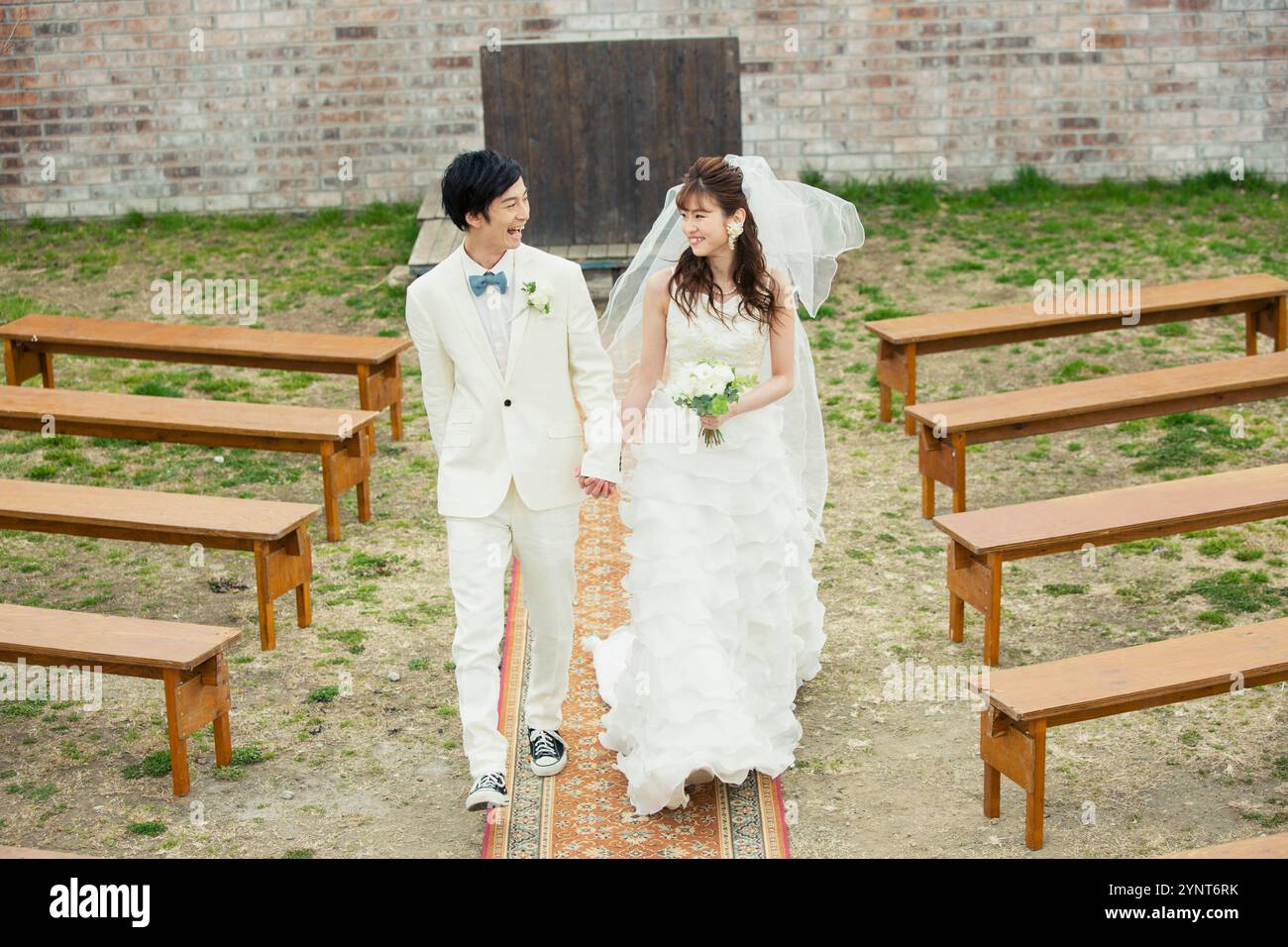 Bride and groom walking down aisle Stock Photo