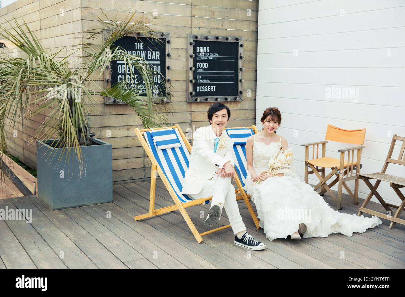 Bride and groom sitting on chair talking Stock Photo - Alamy