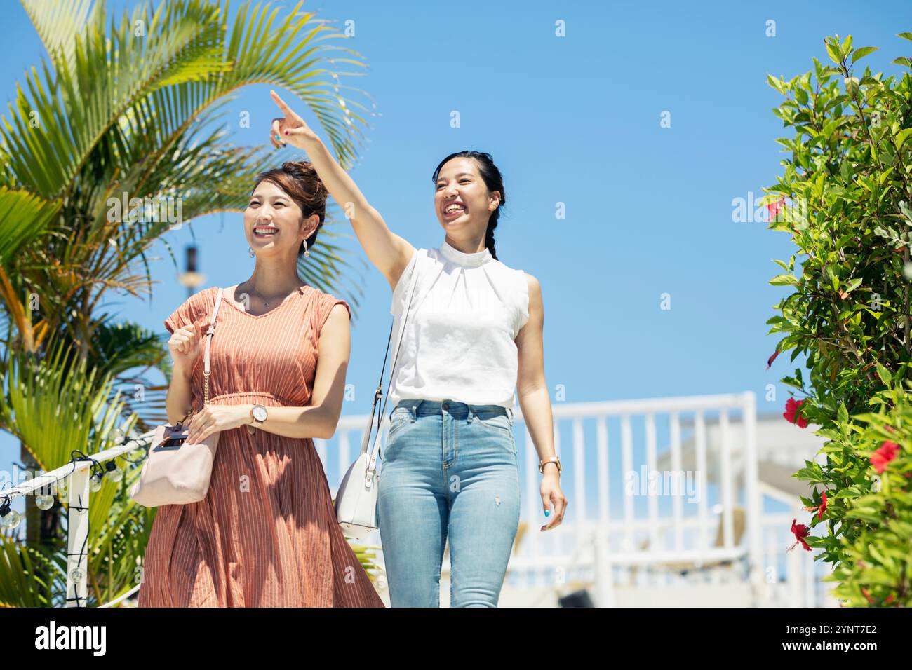 Two women in their 20s enjoying the resort Stock Photo - Alamy
