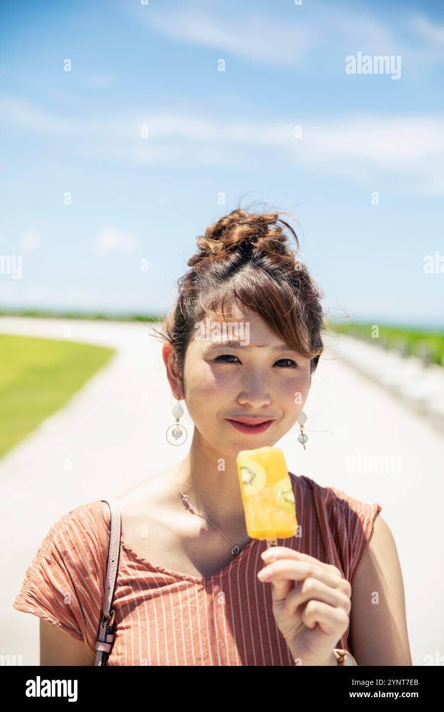 Smiling woman in her 20s with ice cream Stock Photo - Alamy
