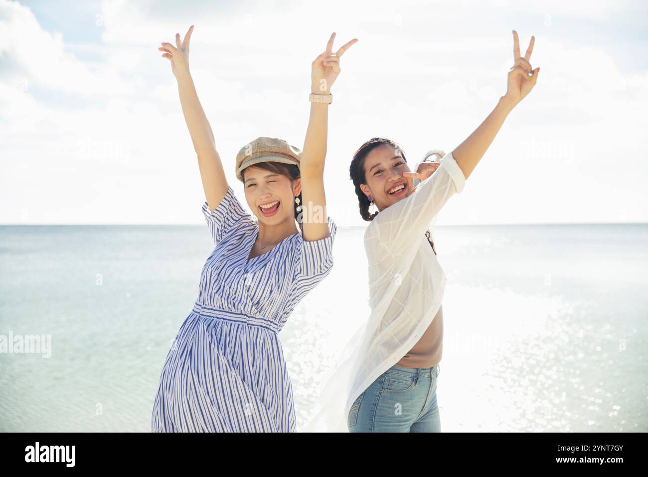 Two women in their 20s enjoying themselves at the sea Stock Photo - Alamy