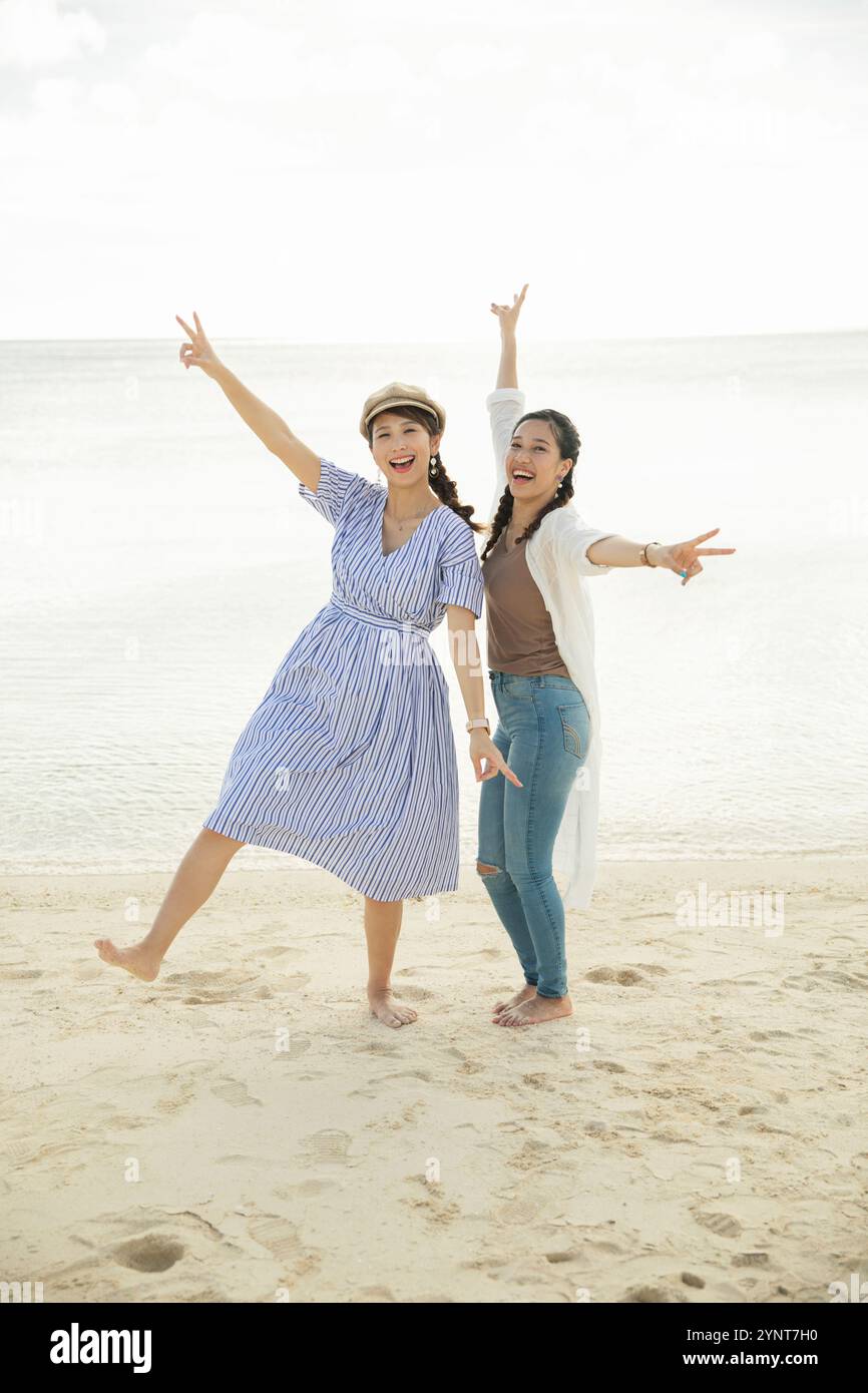 Two women in their 20s enjoying themselves at the sea Stock Photo - Alamy