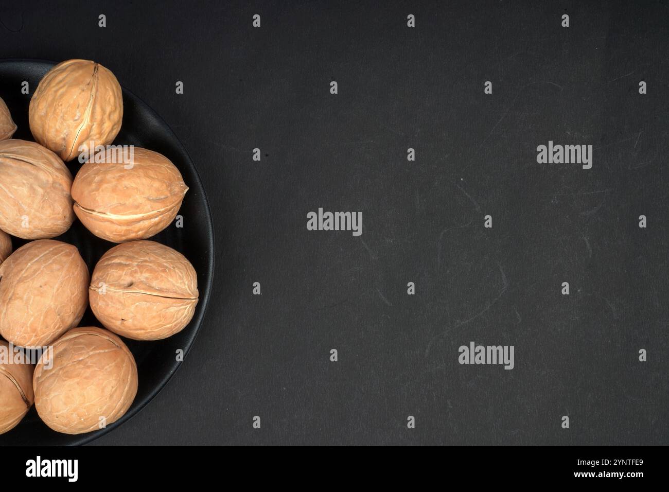 Walnut kernel halves, Closeup top view with black background Stock Photo