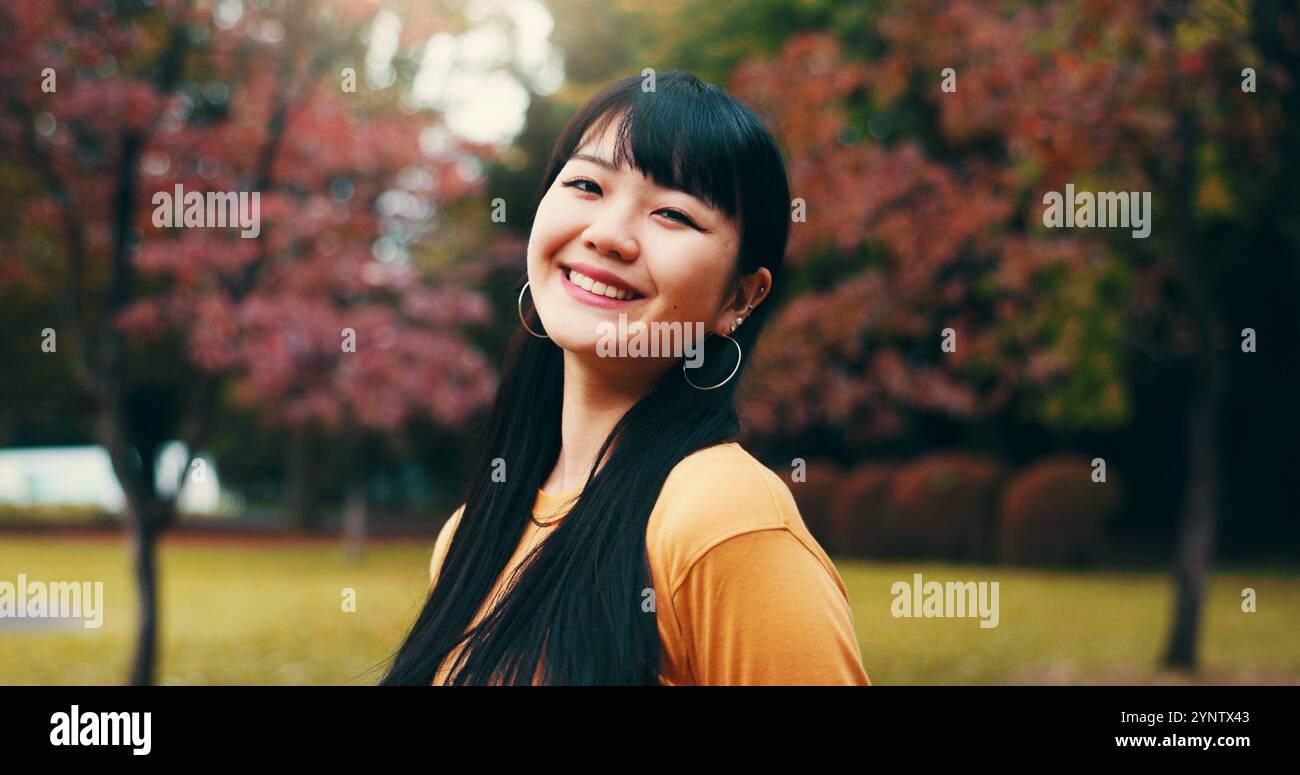 Japanese woman, portrait and outdoor with pride, confidence and smile in garden or park. Female person, happiness and biology student at university Stock Photo