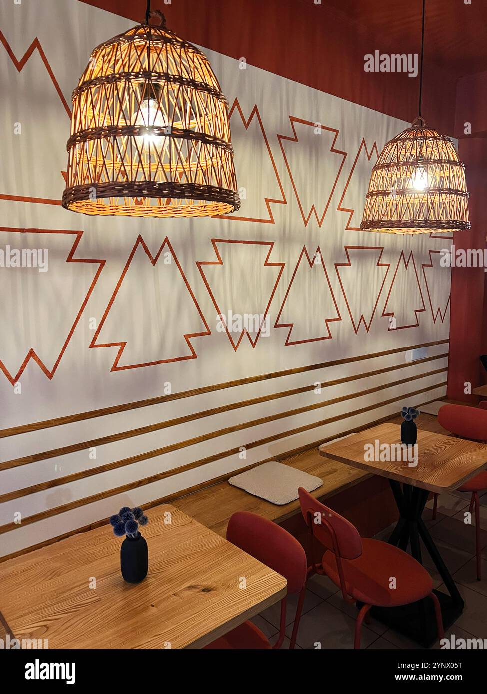 Warm and inviting cafe interior featuring woven basket lamps, wooden ...