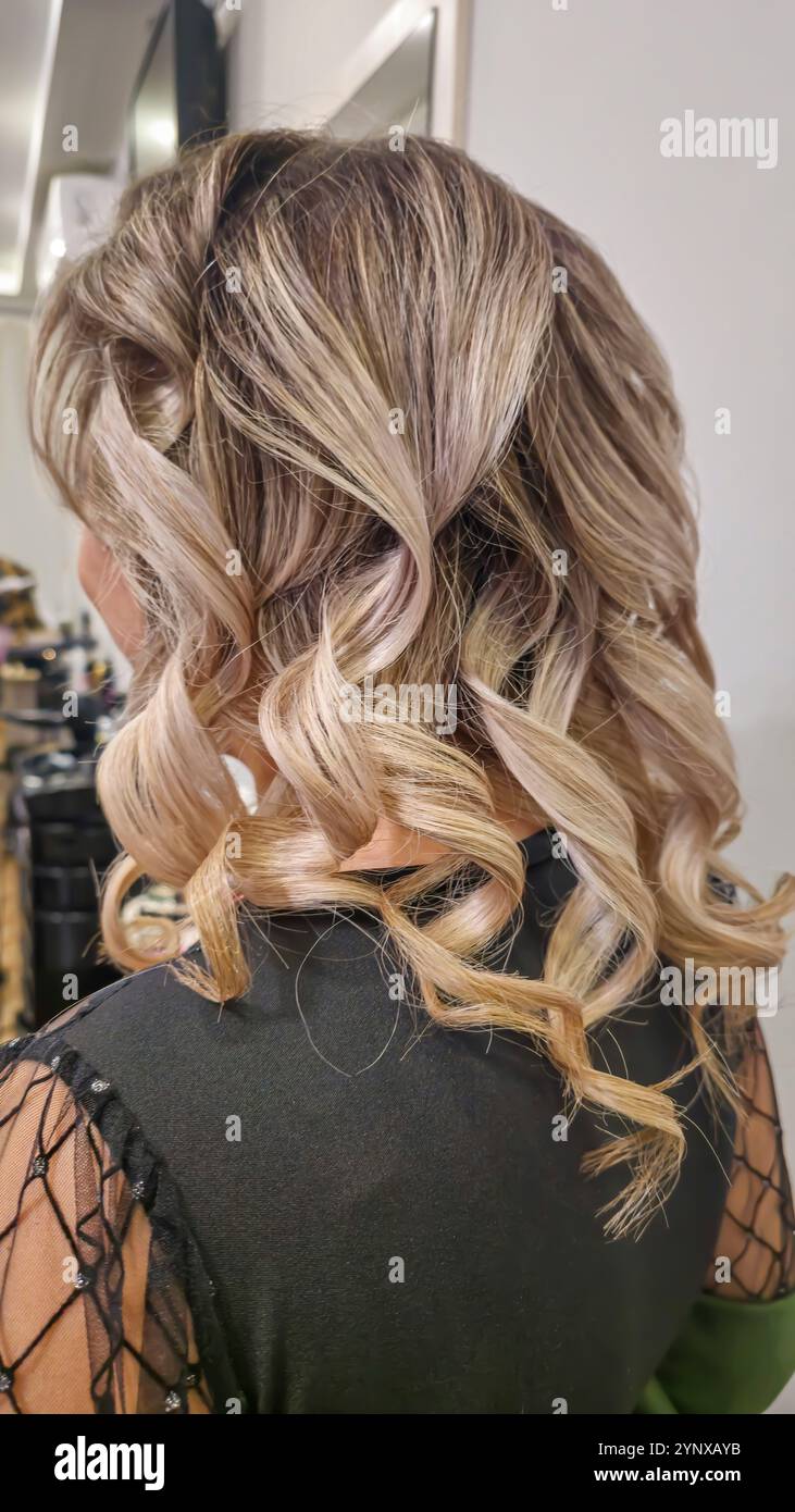 Long hair. Hairstyle in a beauty salon. Salon work. Perm Stock Photo ...