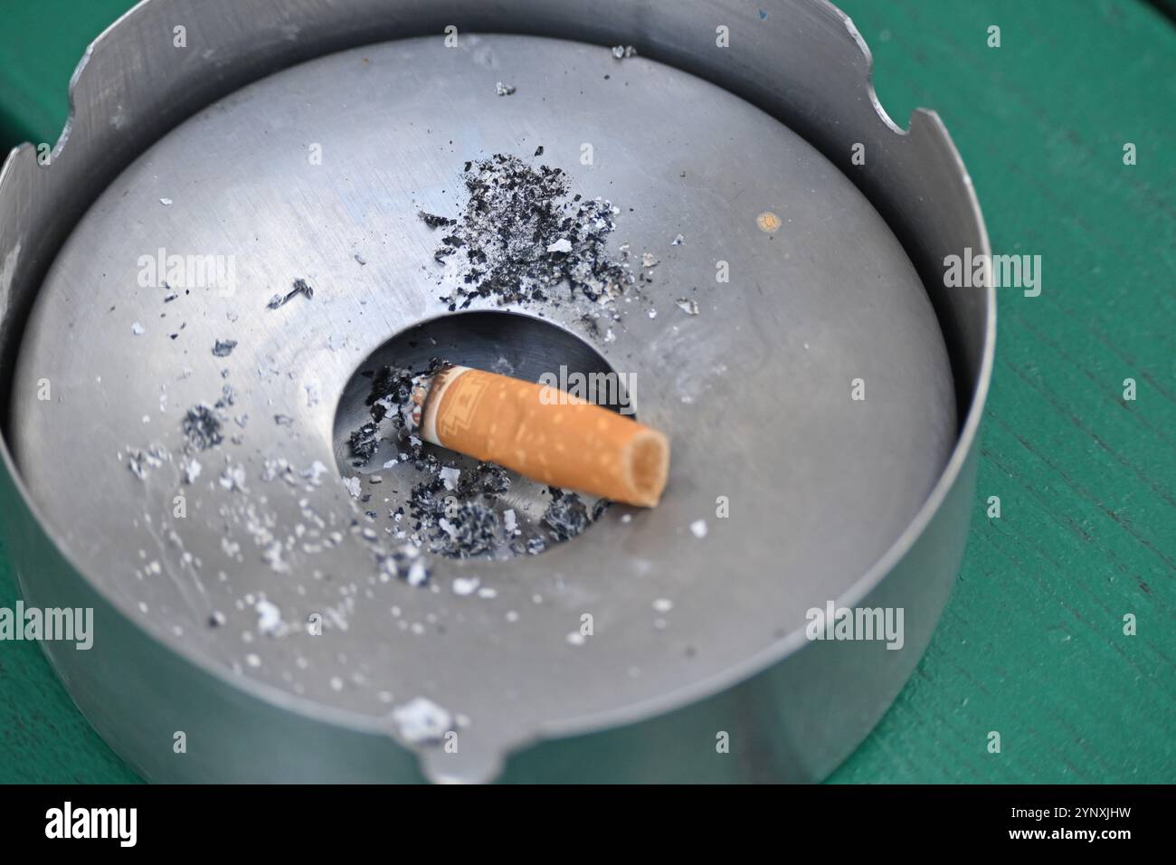 Berlin, Germany. 27th Nov, 2024. A burnt cigarette lies in an ashtray outside. The EU Parliament will vote on resolutions on smoke-free zones on Thursday. MEPs adopt a declaration on a proposal from the EU Commission on smoke-free outdoor areas. Credit: Anna Ross/dpa/Alamy Live News Stock Photo