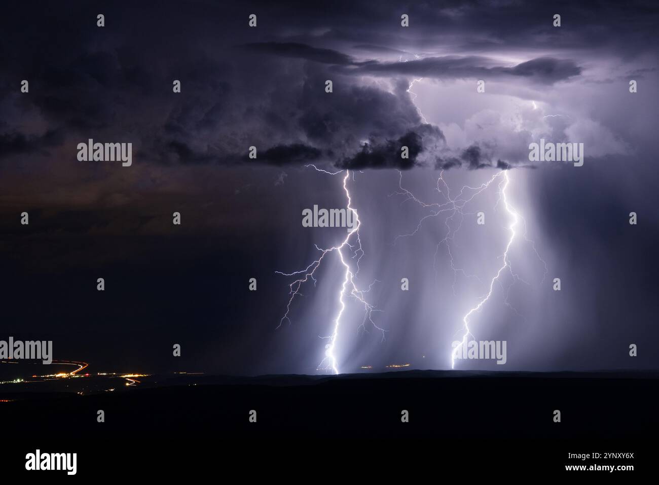 Forked lightning bolts strike from a thunderstorm over the Verde Valley ...