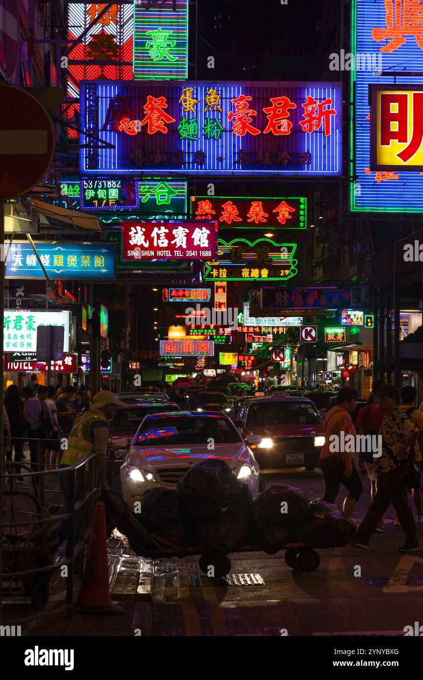 Bustling street scene in Hong Kong downtown with pedestrians crossing ...