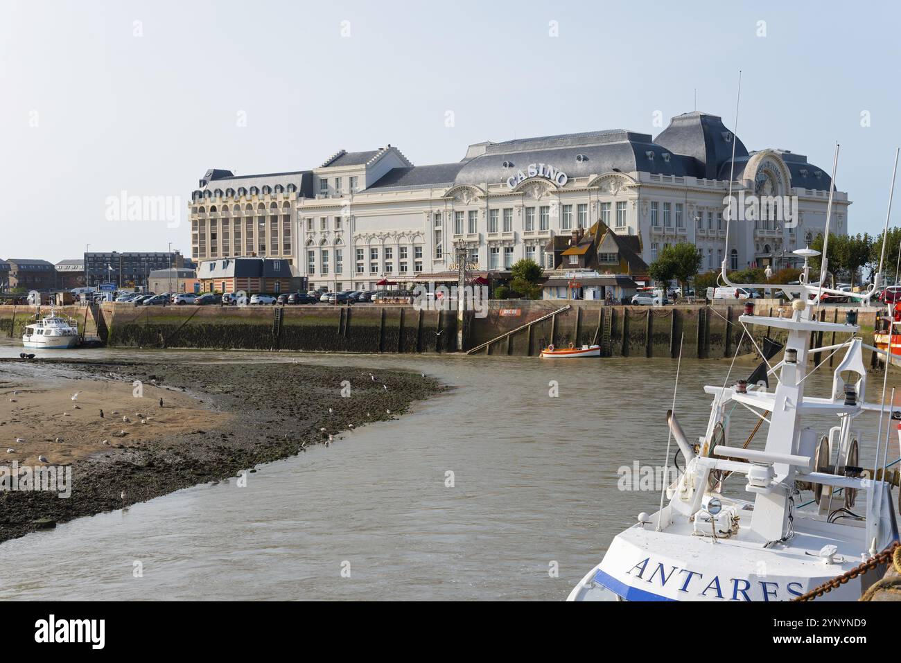Large historic riverside building with boats in the foreground, Casino Barriere, casino, Trouville-sur-Mer, Trouville, River Touques, CRur Cote Fle Stock Photo