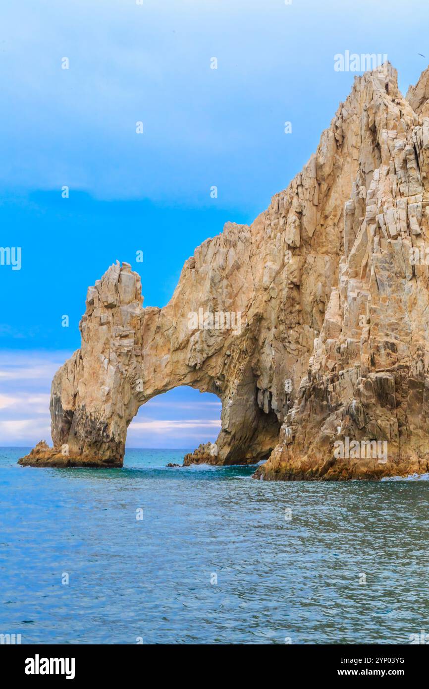 A large rock formation with a large hole in the middle of it. The sky ...