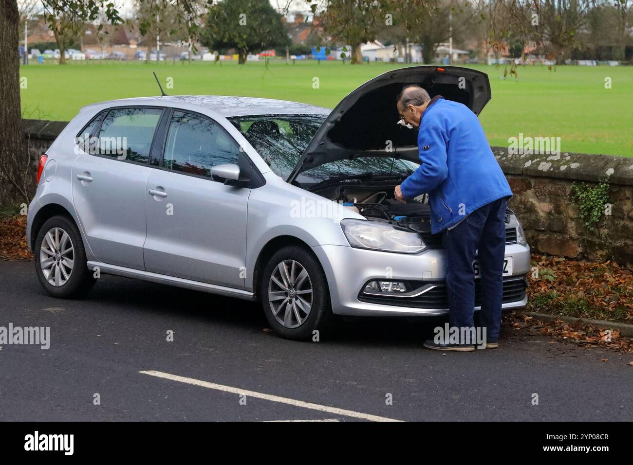 An older Man checking his car engine oil level Stock Photo - Alamy