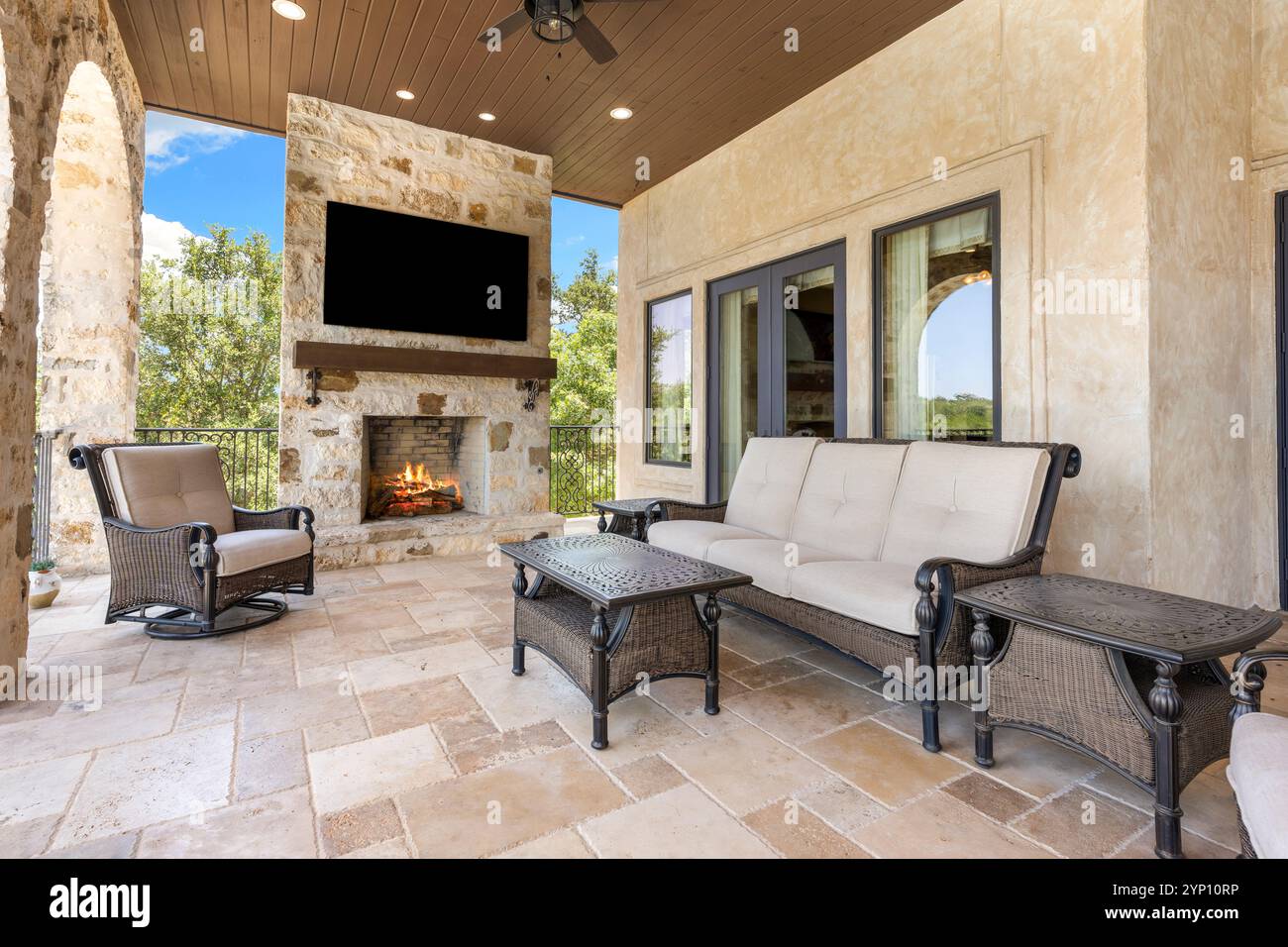 Elegant outdoor living space with fireplace and modern furnishings