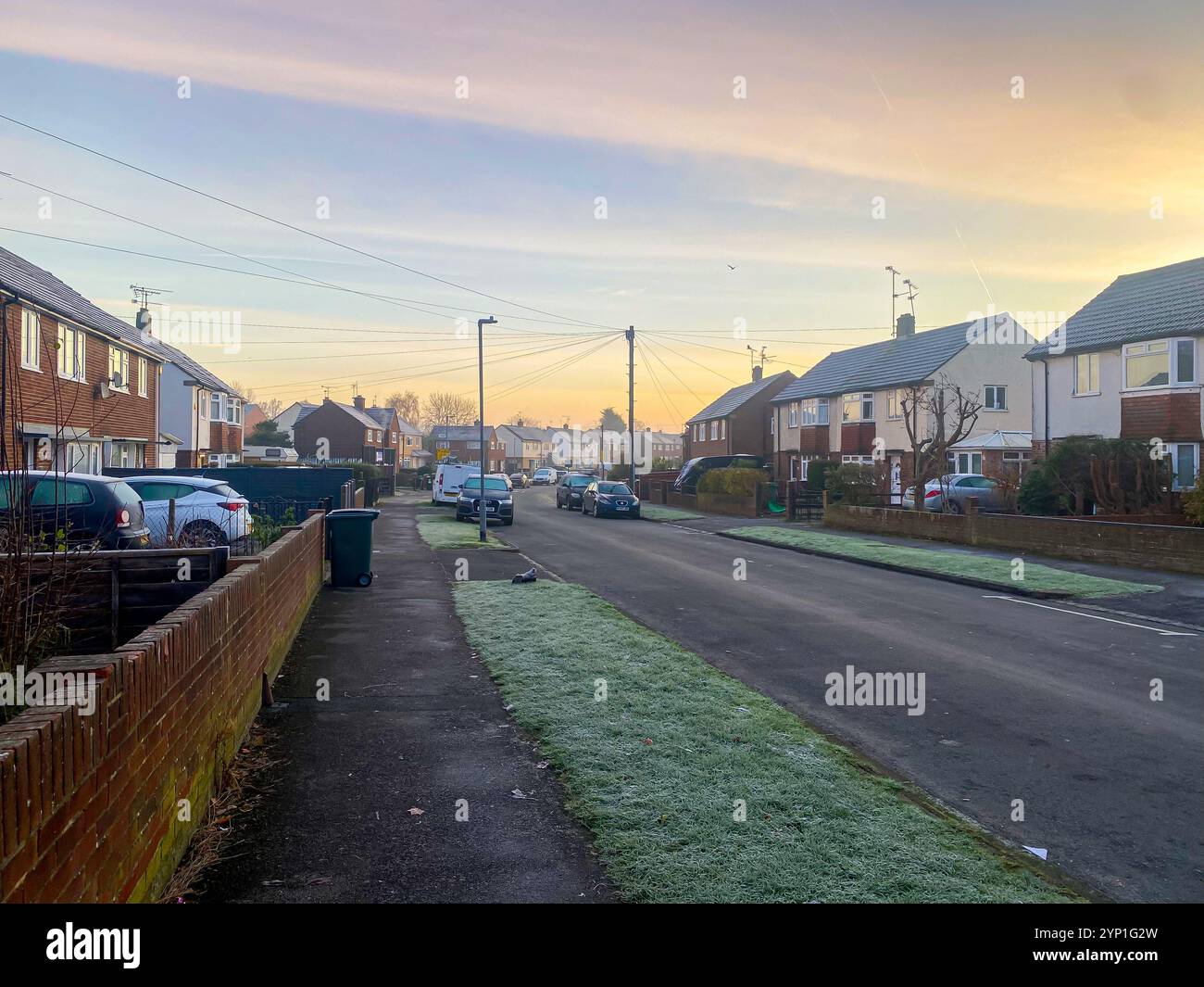 View along a suburban street early on a frosty morning in early winter. - Smartphone Captured Stock Image