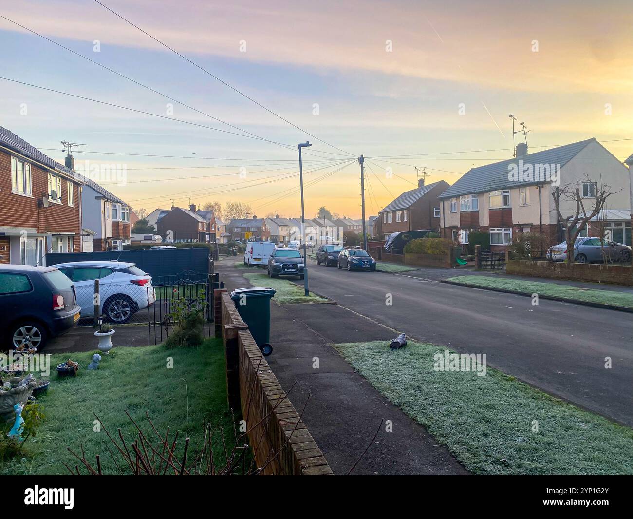 View along a suburban street early on a frosty morning in early winter. - Smartphone Captured Stock Image