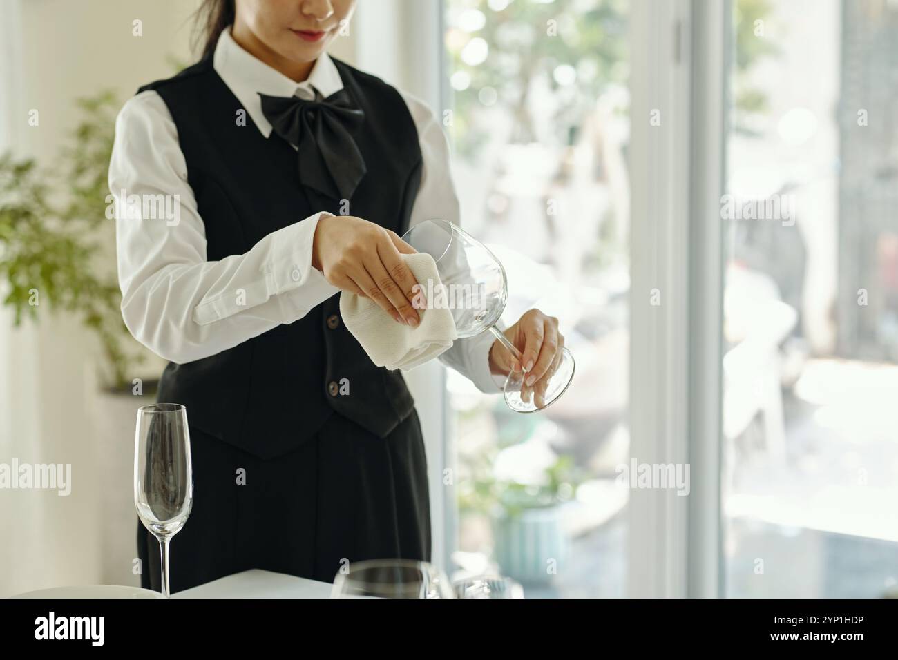 Cleaning Wine Glass in Elegant Dining Setting Stock Photo