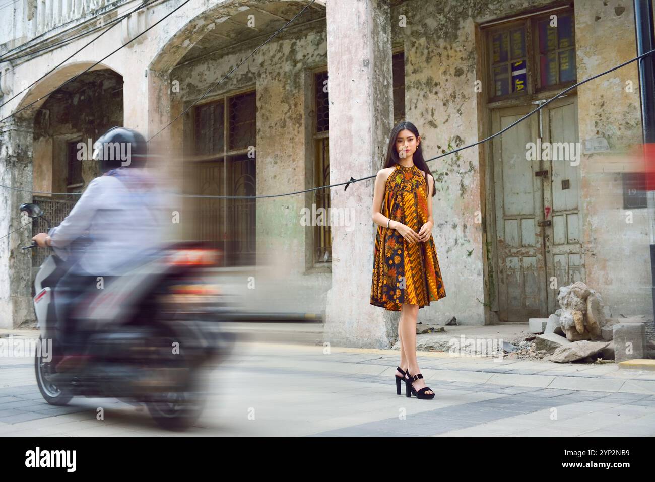 Young Indonesian girl posing in a batik dress in the Kepodang Street ...