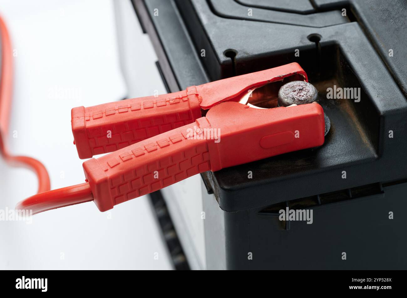 Checking voltage on car battery with jumper close up view Stock Photo