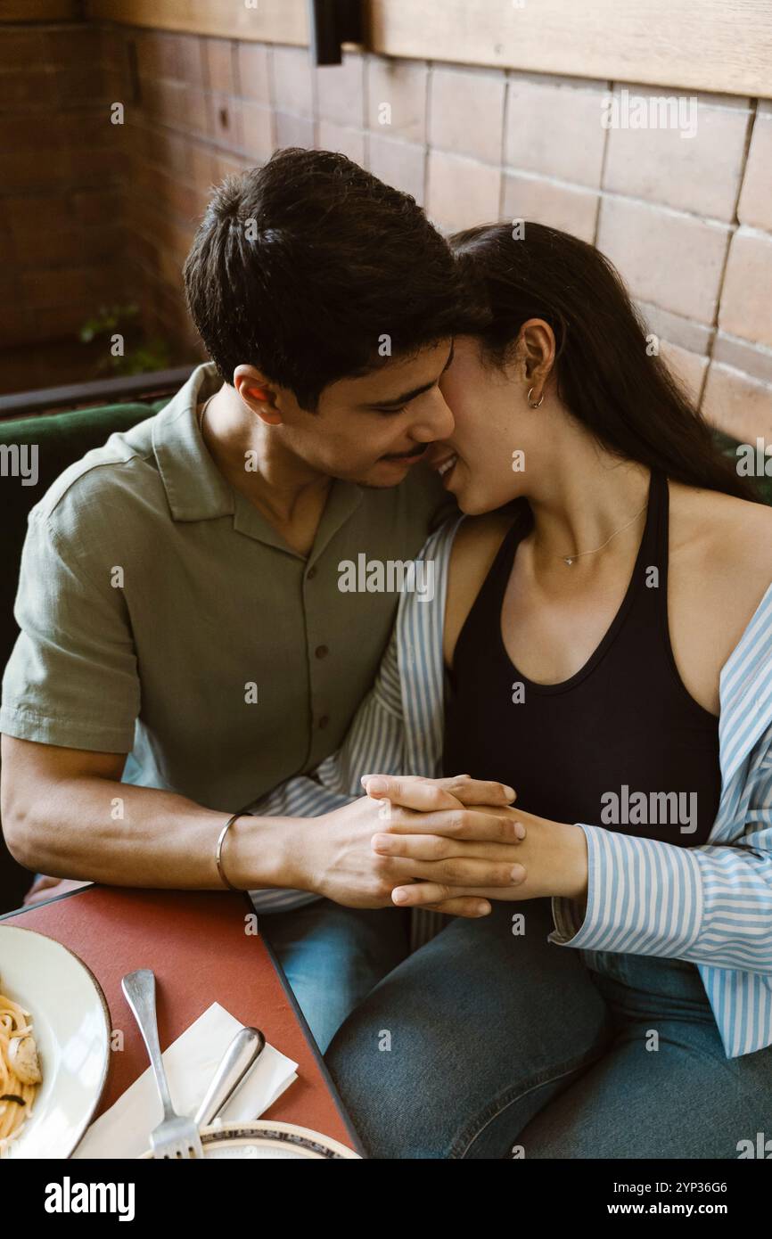 High angle view of romantic couple with hands intertwined at restaurant Stock Photo