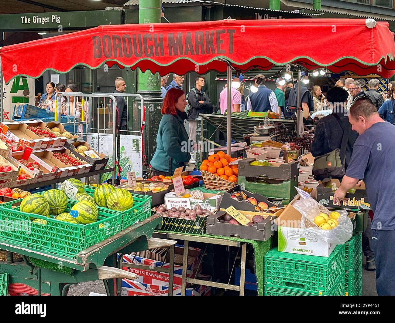 London, England, UK - 3 July 2024: People at a grocery stall in Borough Market in central London - Smartphone Captured Stock Image