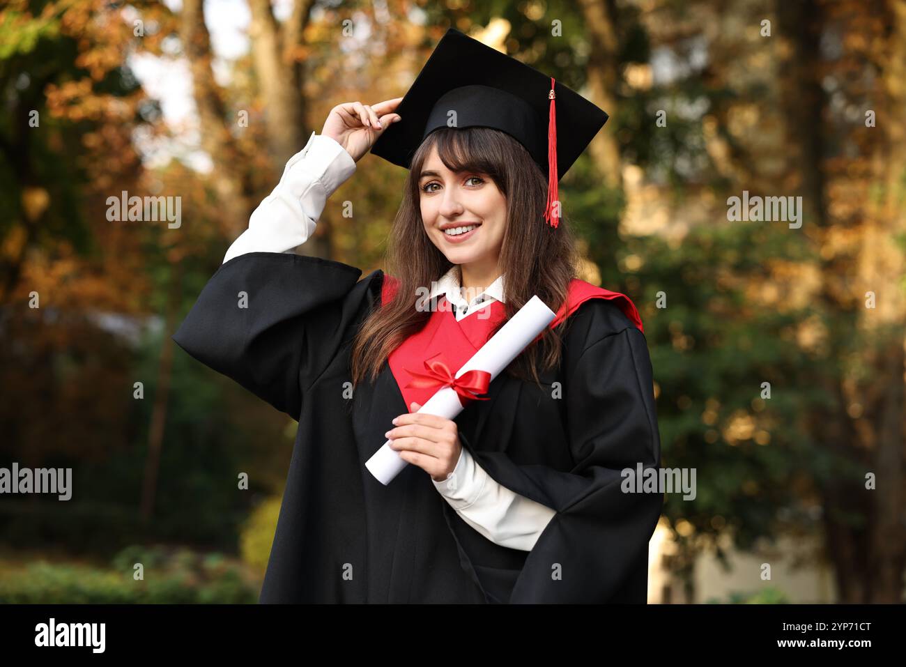Happy student with diploma after graduation ceremony outdoors Stock ...
