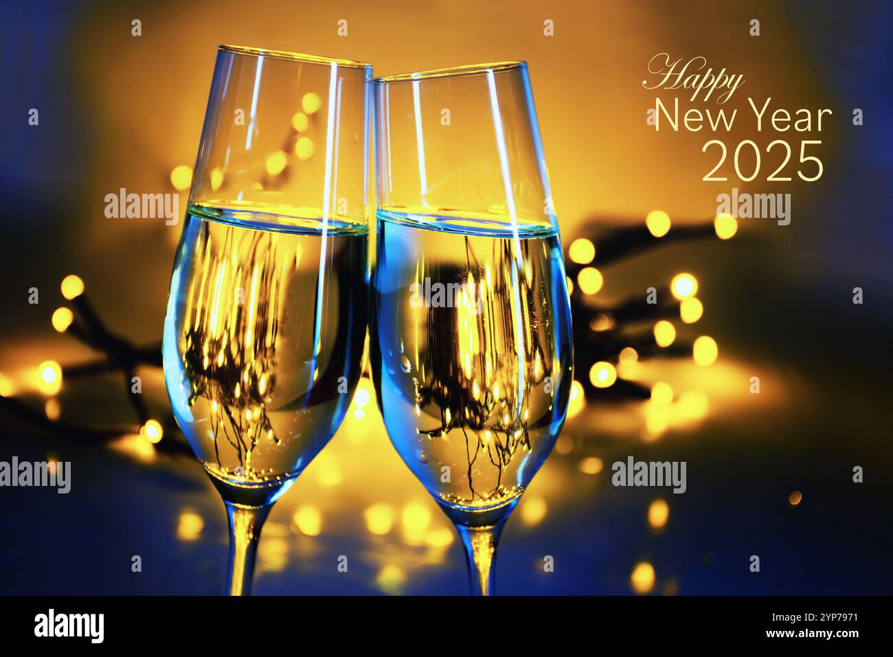 Happy New Year 2025 with two champagne flutes clinking glasses at a party, warm golden background with blurred lights and copy space, selected focus Stock Photo