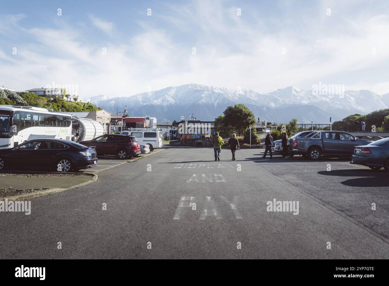 Car park with cars and background of snow-capped mountains under a clear sky, Lake Tekapo, New Zealand, Oceania Stock Photo