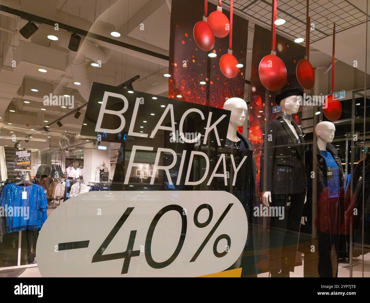 Black Friday discount sign on a shopping mall window, women's clothing store - Smartphone Captured Stock Image