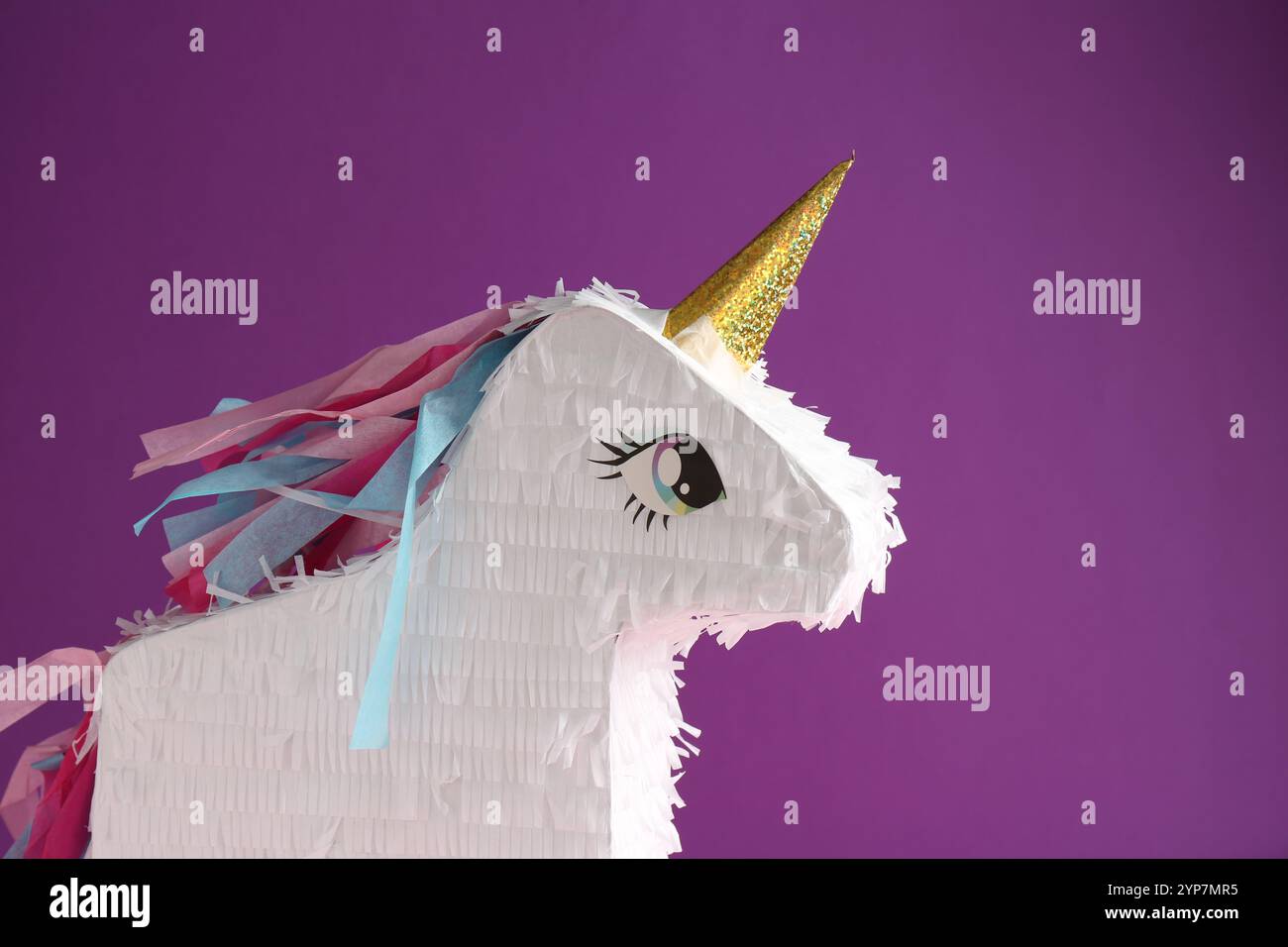 Bright pinata in shape of unicorn on purple background Stock Photo - Alamy