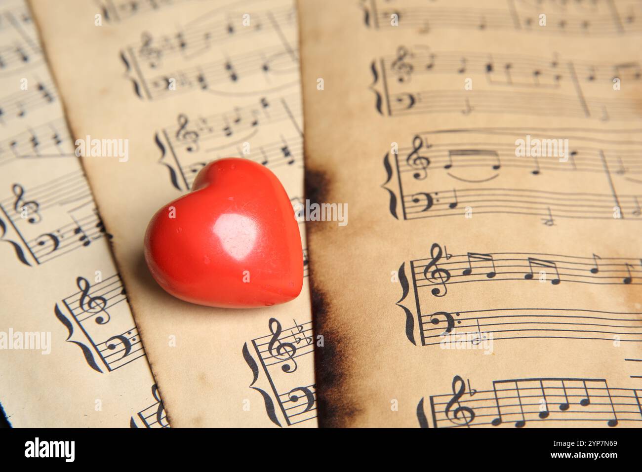 Heart figure on musical note sheets, closeup Stock Photo