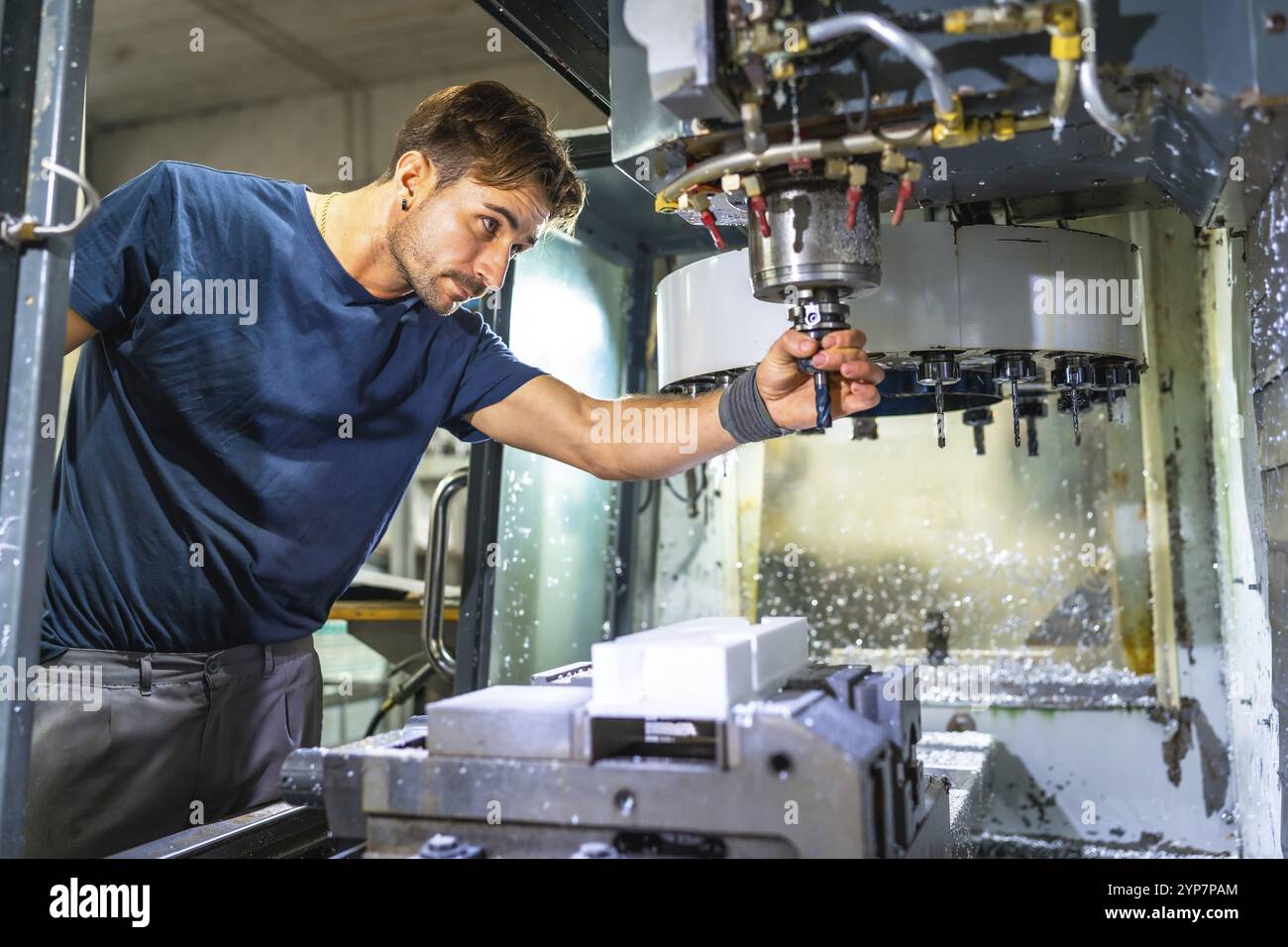 Male caucasian technician working with mechanic machine to produce ...