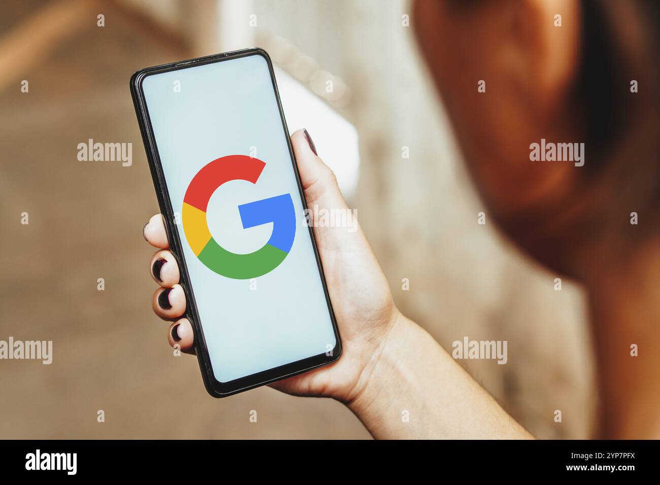 In this photo illustration, the Google logo is displayed on a smartphone screen Stock Photo