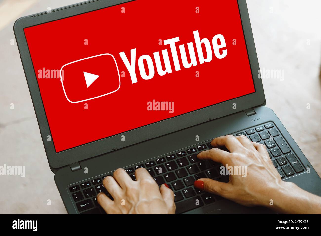 In this photo illustration, the YouTube logo is displayed on a notebook screen Stock Photo