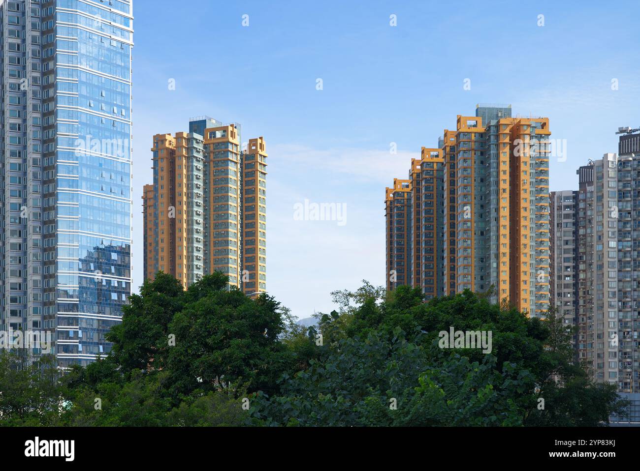 Orange and blue high rise residential buildings in Hong Kong on a clear ...