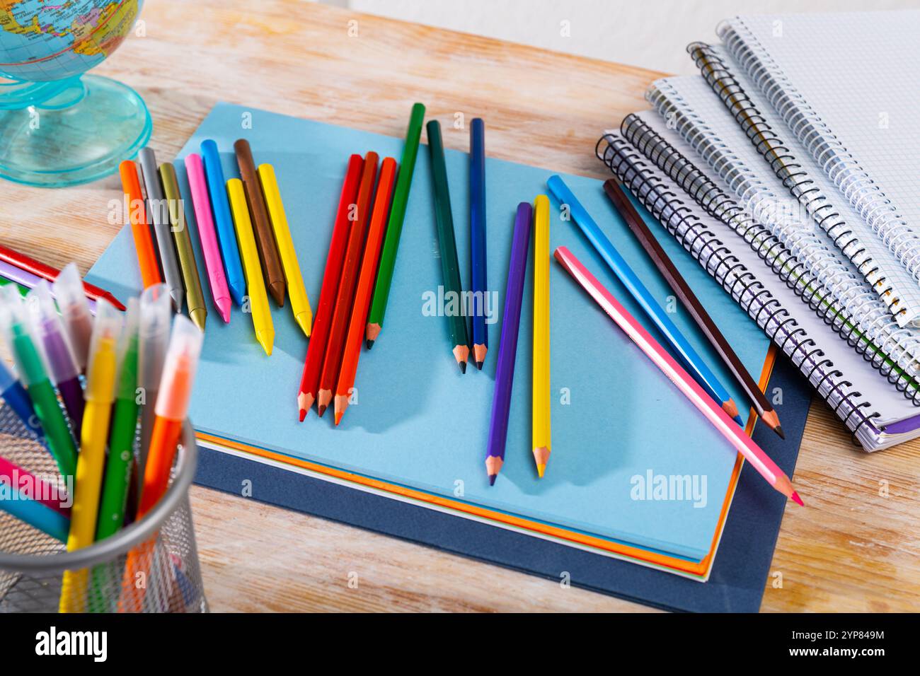 Colored pencils kept in pencil holder Stock Photo