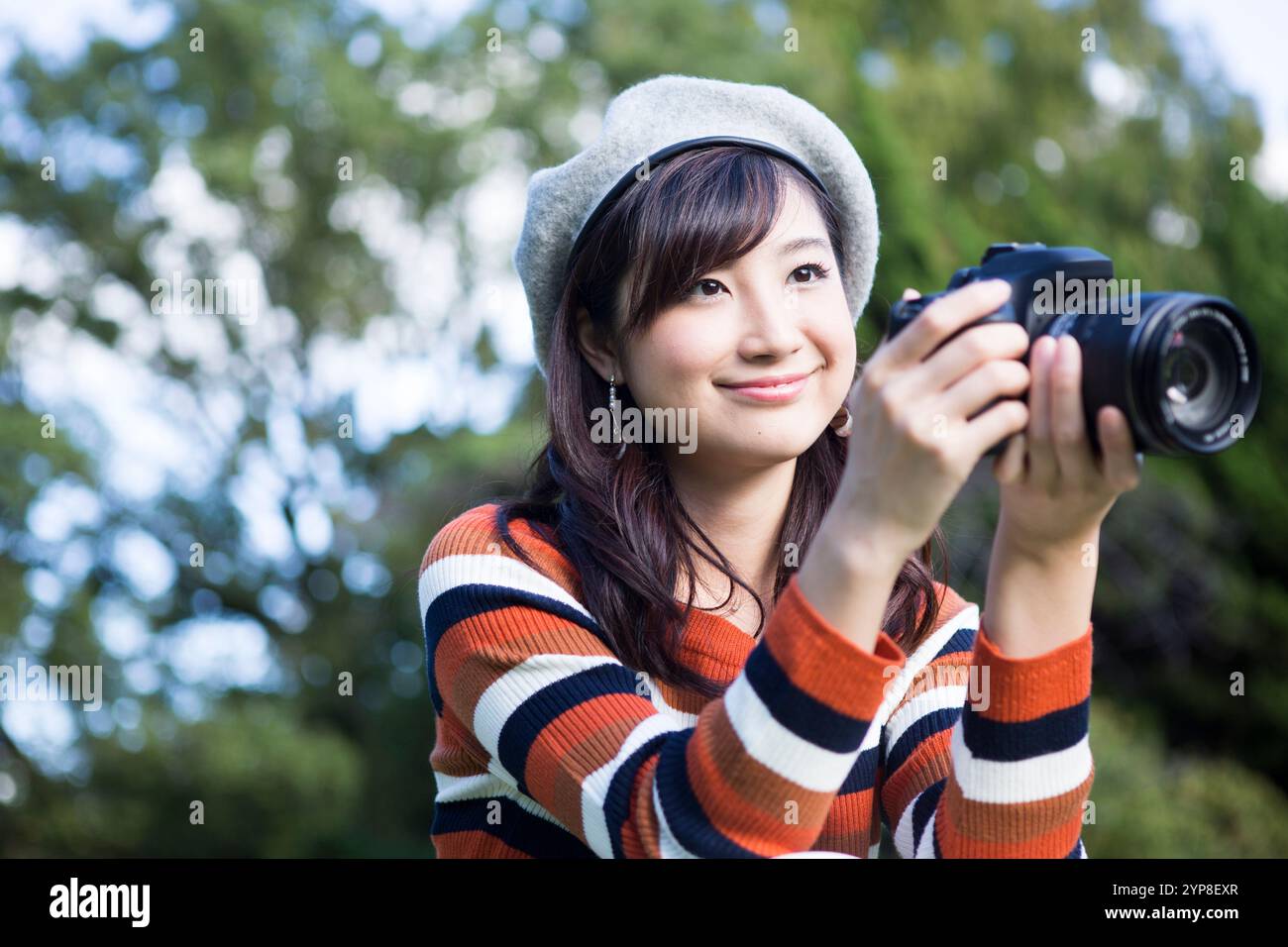 Woman filming in park hi-res stock photography and images - Alamy