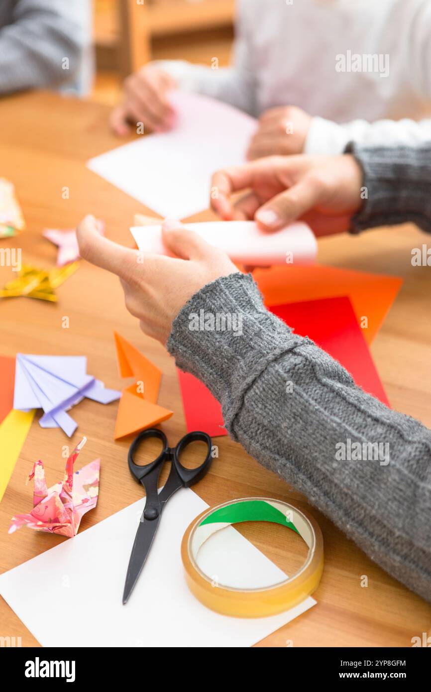 Man's hand folding origami Stock Photo