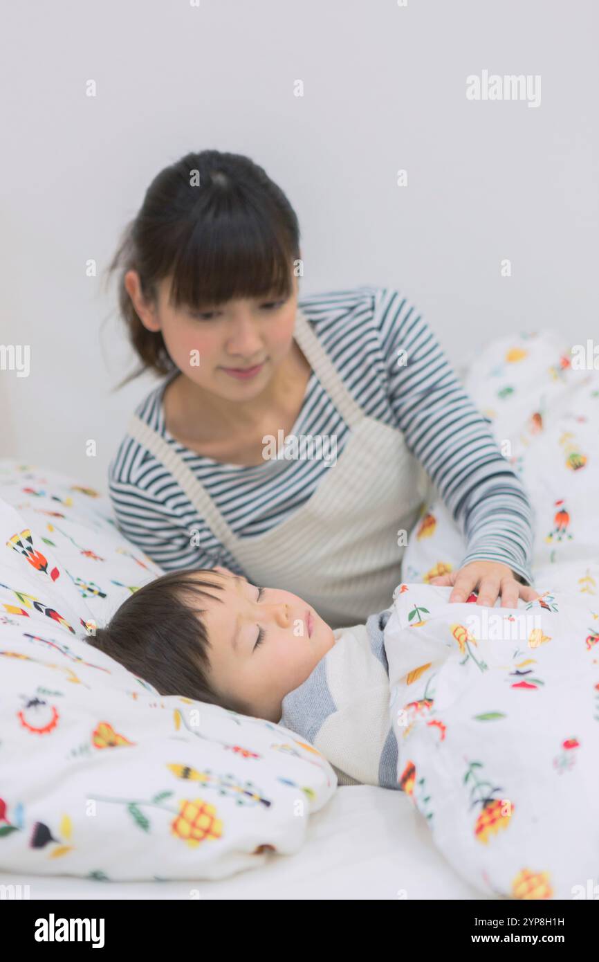 mother-putting-her-child-to-bed-stock-photo-alamy