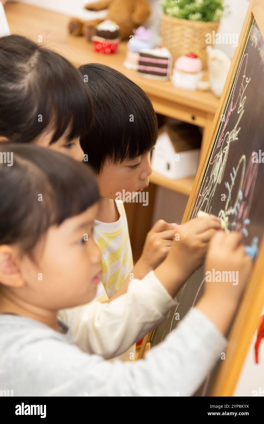 Happy children drawing in classroom hi-res stock photography and images ...