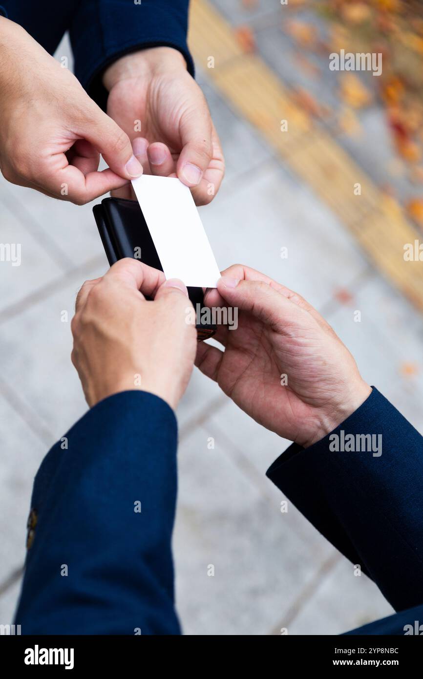Hand holding a business card exchanging Stock Photo