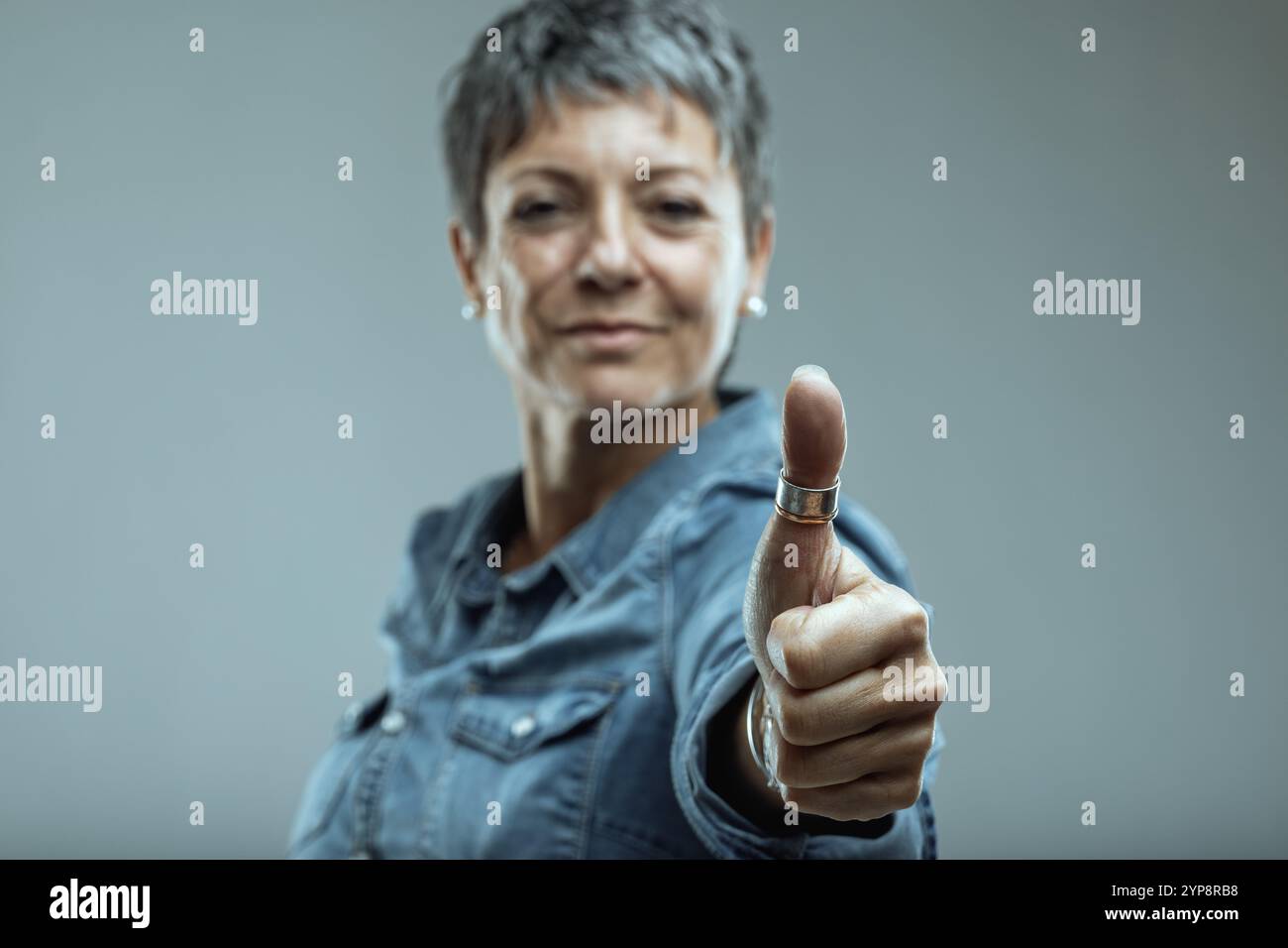 Senior woman gives thumbs up hi-res stock photography and images - Alamy