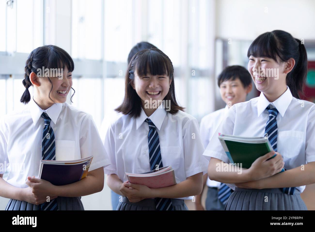 Junior high school students walking in corridor Stock Photo - Alamy