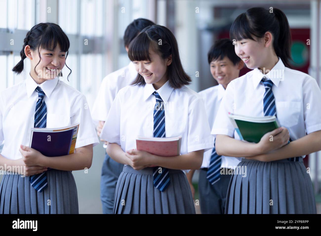 Junior high school students walking in corridor Stock Photo - Alamy