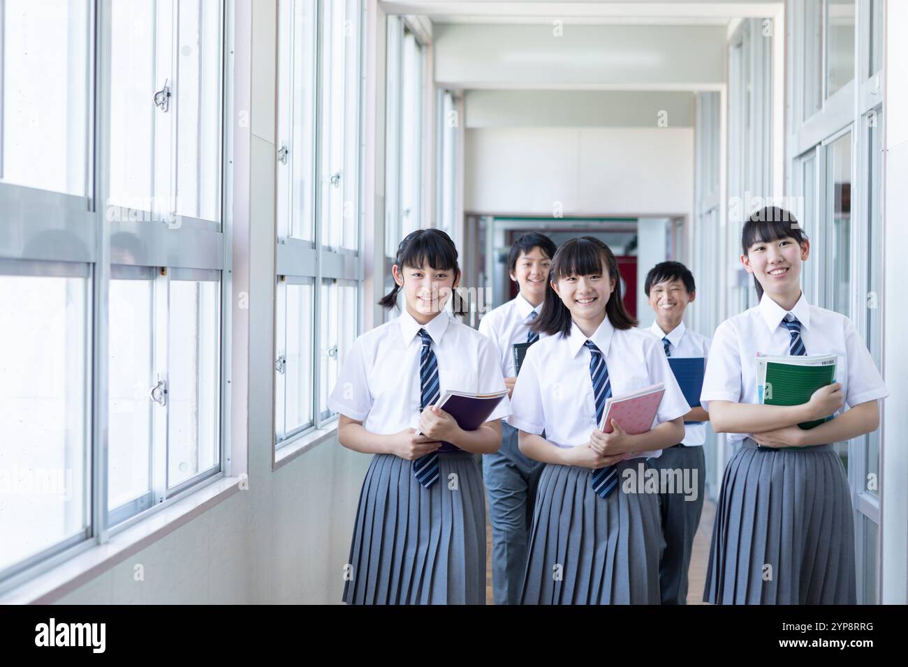 Junior high school students walking in corridor Stock Photo - Alamy